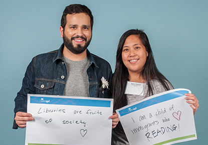 library staff holding signs saying 'libraries are fruits of society'