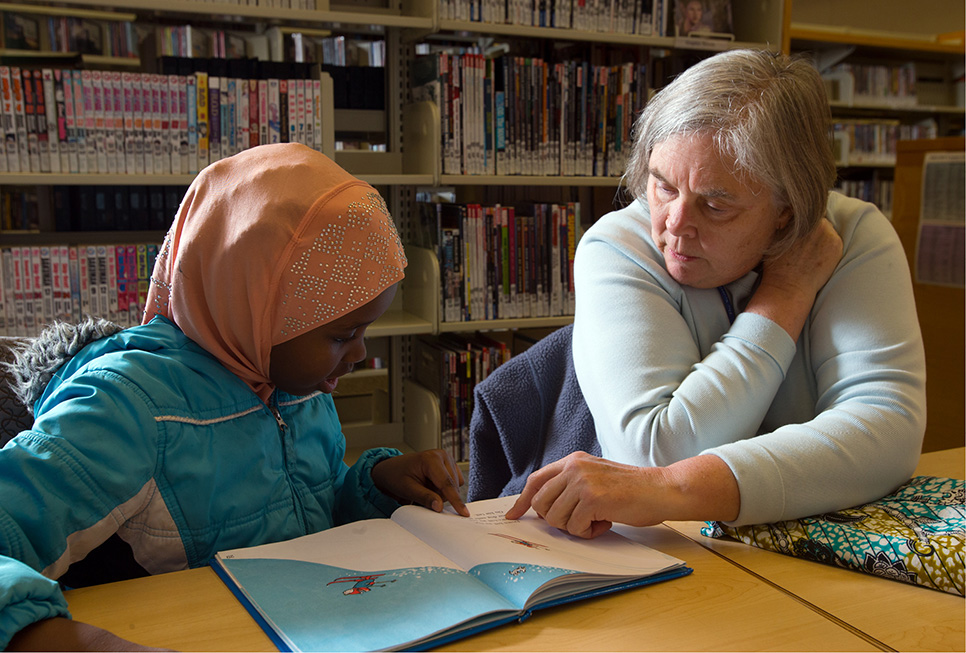 Young patron receiving homework help from a Library volunteer at our High Point branch