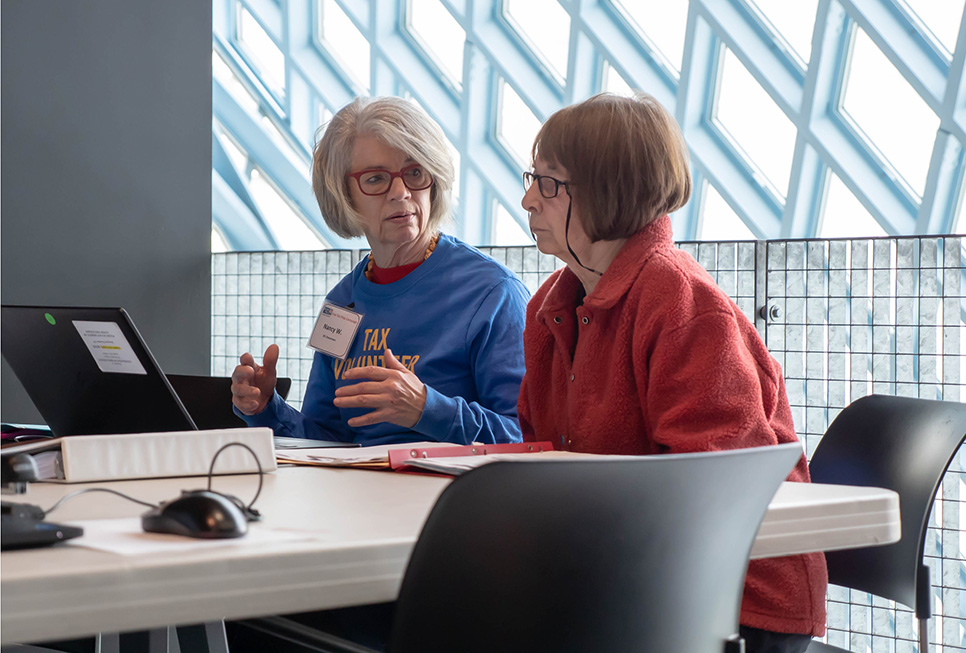 Patron receiving tax help at the Central Library from trained volunteers.