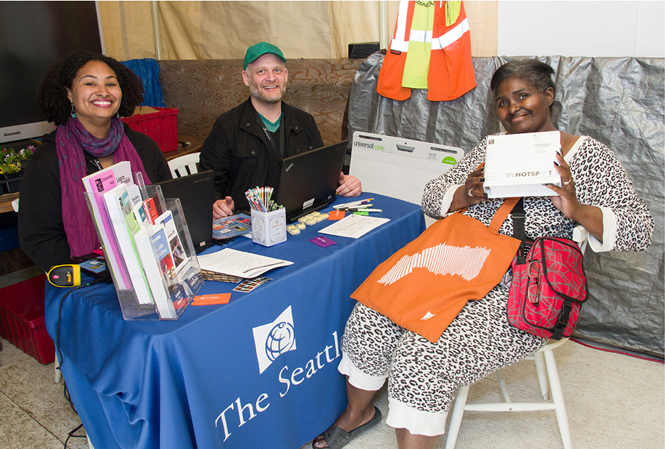 Library staff helping a patron check out a SPL hotspot at the Camp Second Chance