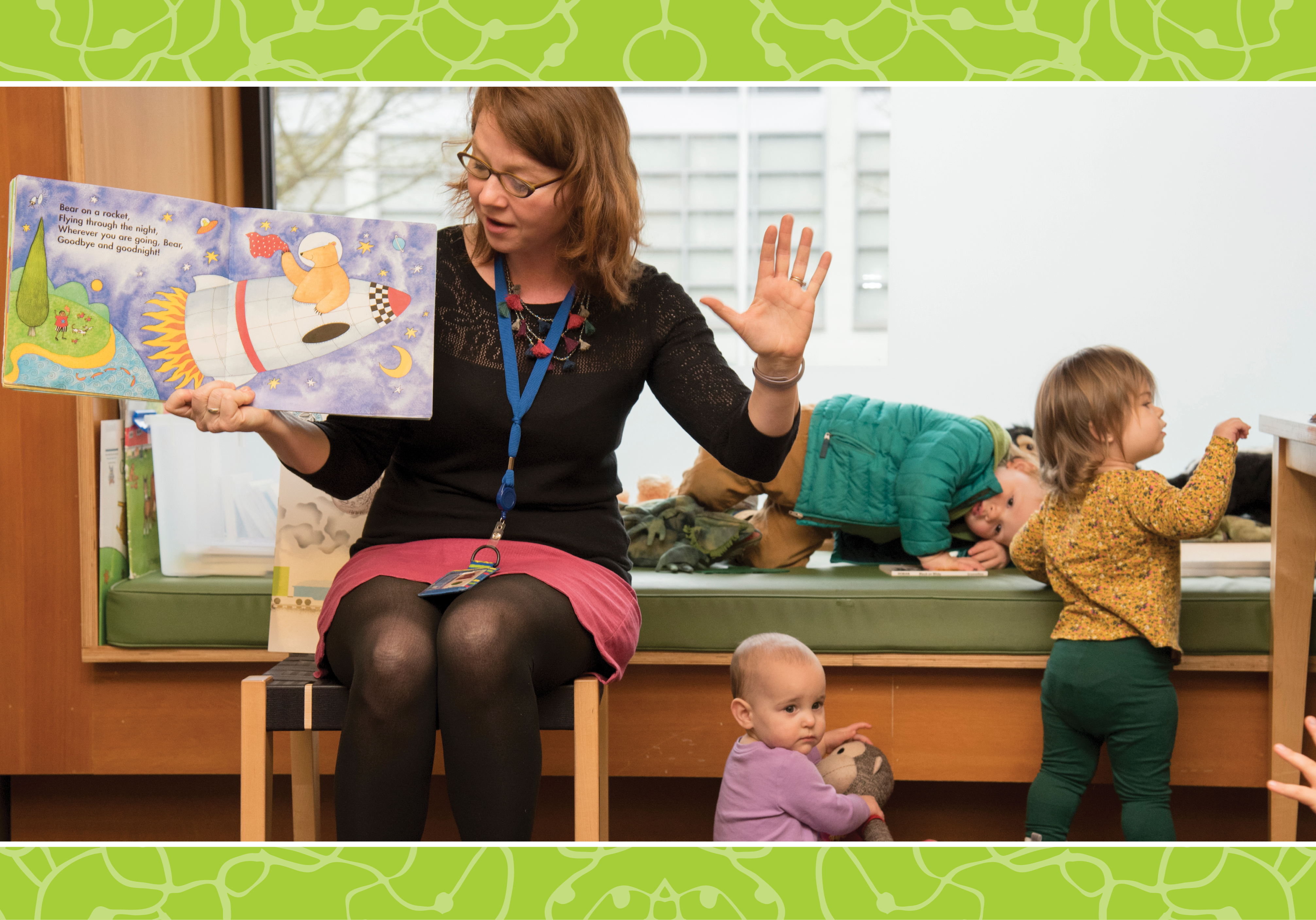 Librarian reading to young patrons at a story time event