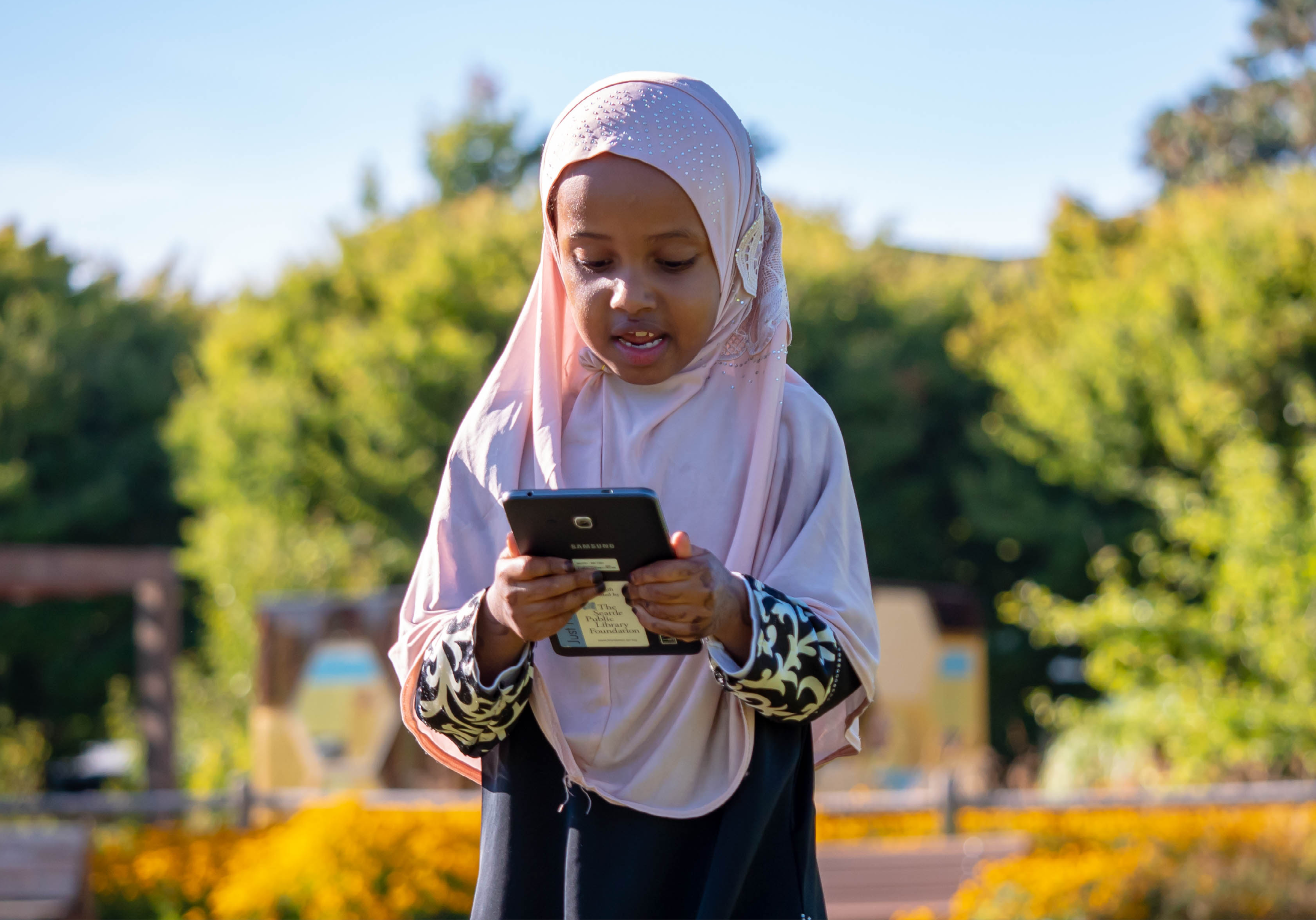 Young patron using a tablet at a Summer of Learning event