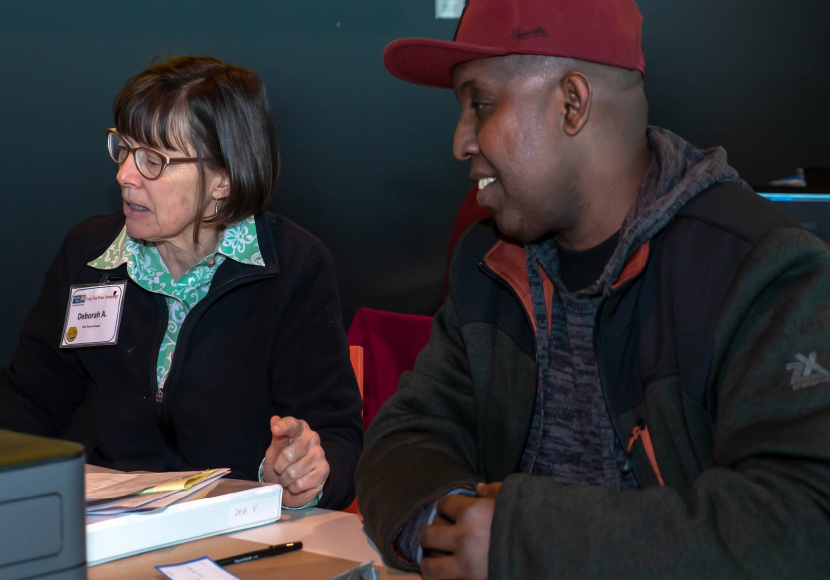 Patron and Library volunteer at a tax help event