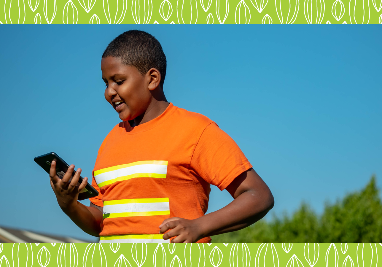 Library patron using a mobile device at a Summer of Learning event.