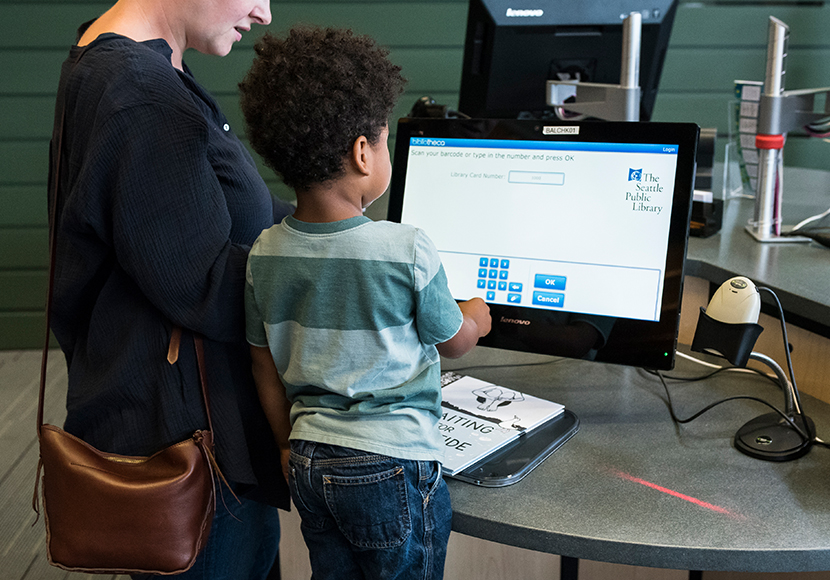 Woman and child at a computer.