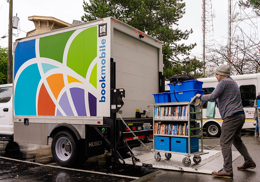 Person loading materials into bookmobile