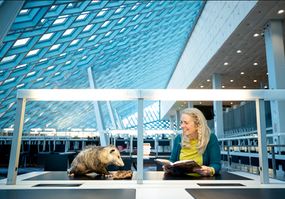 Children's Librarian Betsy Kluck-Keil reads to Clyde the opossum