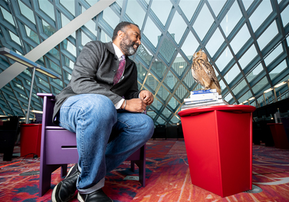 Chief Librarian Marcellus Turner and Buddy the pharaoh eagle owl