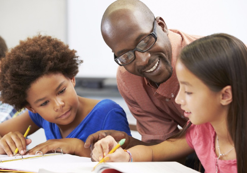 Adult volunteer helping young patron