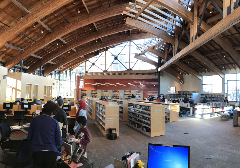 Library patron at service desk area at the Beacon Hill Branch