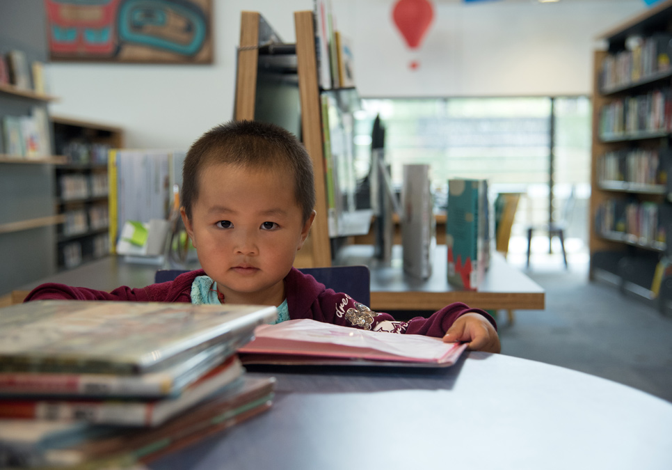 Child reading in children’s area at the Broadview Branch