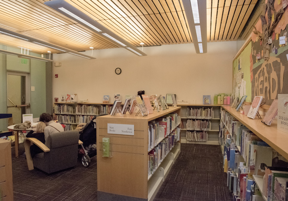 Family reading in children’s area at the Capitol Hill Branch