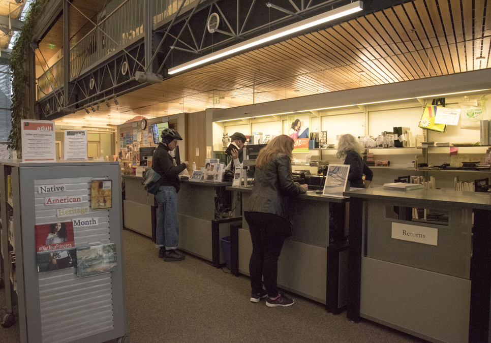 Library patrons at service desk area at the Capitol Hill Branch