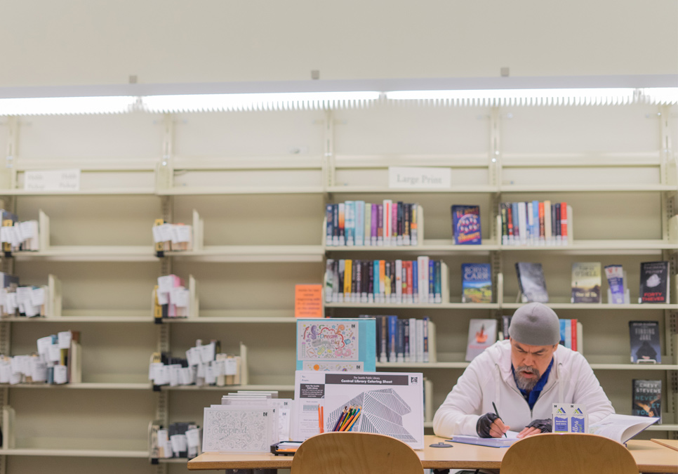 Library patron in seating area at the Delridge Branch