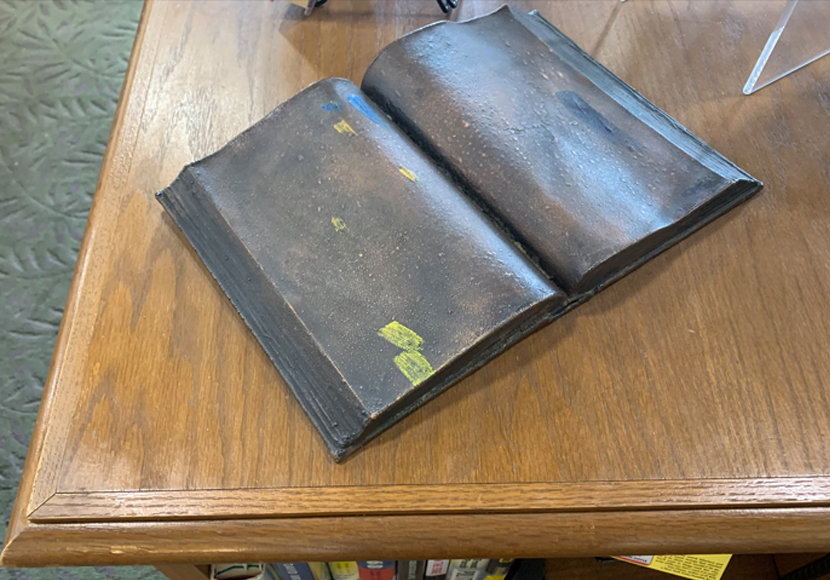 Sculpture showing two books.