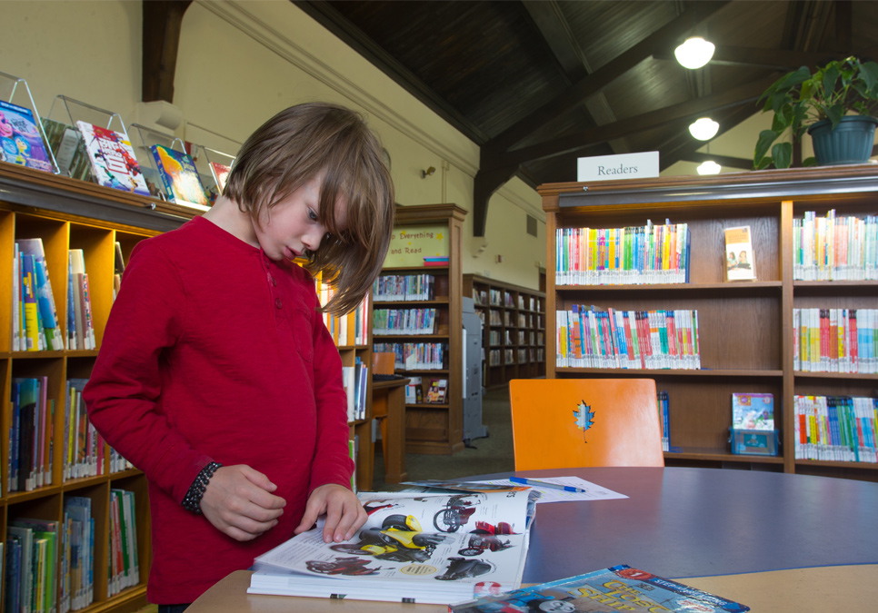 Child reading in children’s area at the Fremont Branch