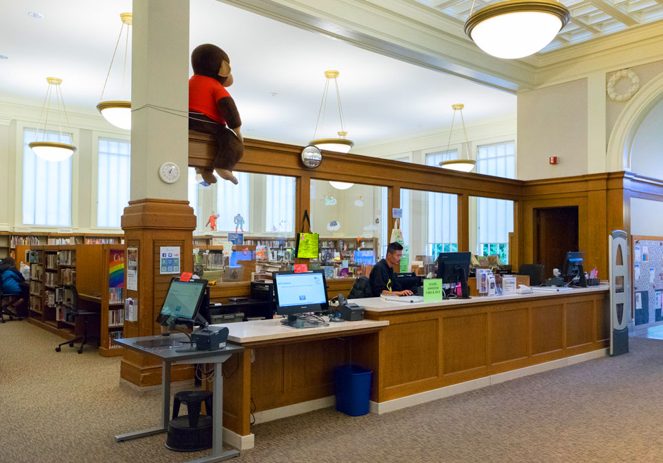 Library staff at the service desk area at the Green Lake Branch