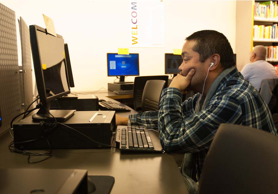 Library patron using public computer at the International District/Chinatown Branch