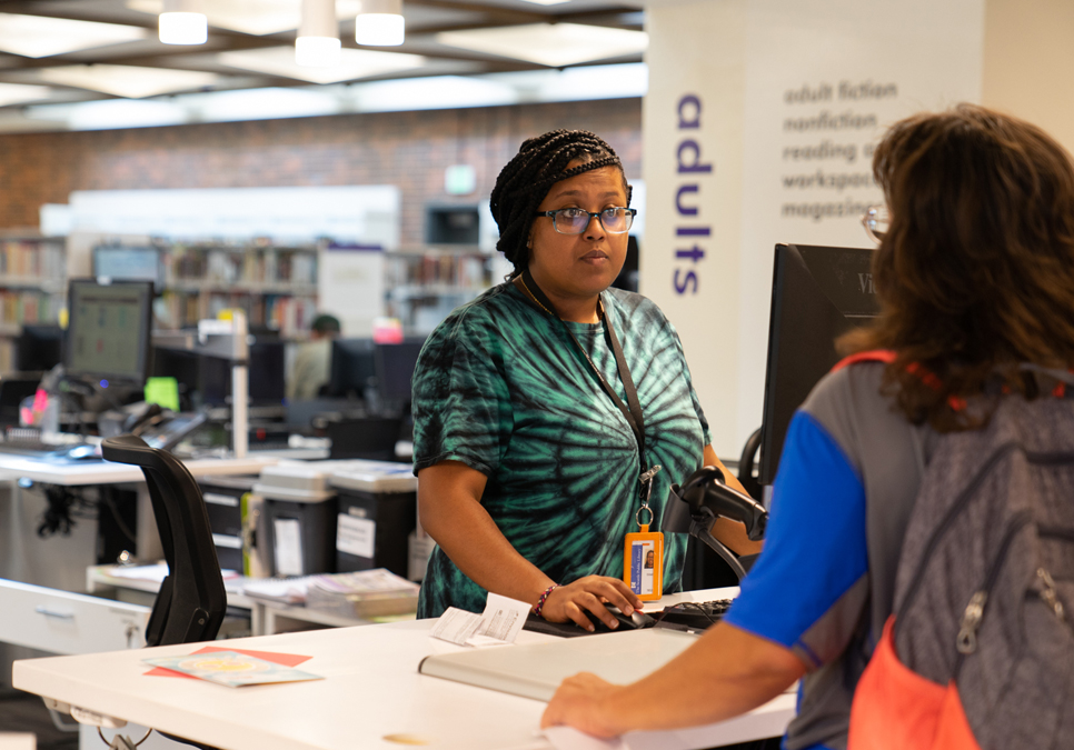 Library staff and patron at the Lake City Branch