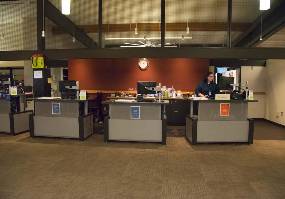 Library staff at the service desk area at the Northeast Branch