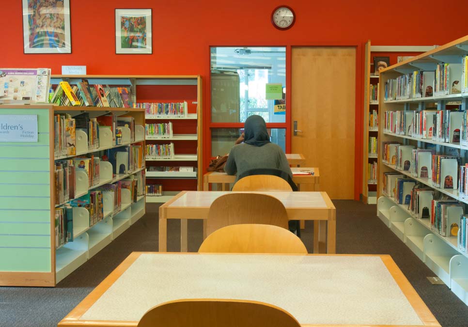 Library patron reading at the NewHolly Branch