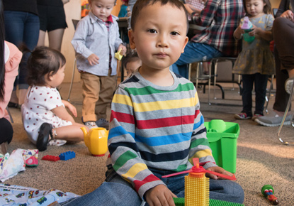 child playing at library event
