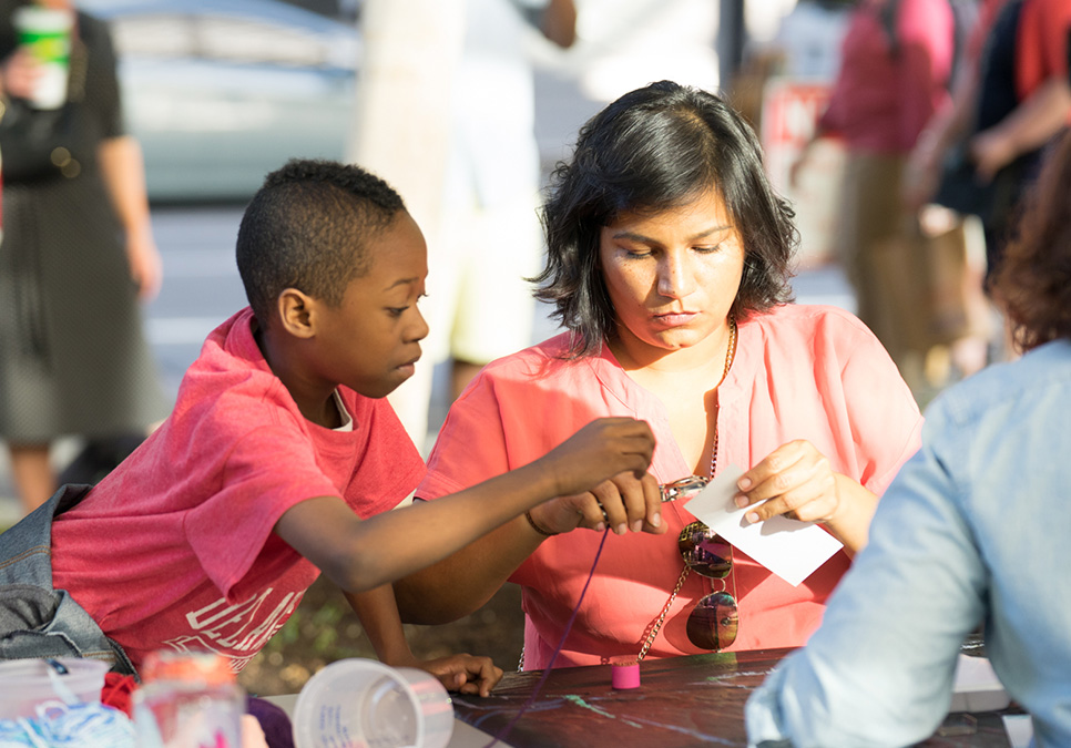 Family crafting at art on the plaza event at the Central Library