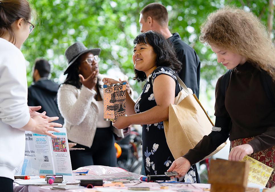 Patron looking at art and crafts at the art on the plaza event at the Central Library