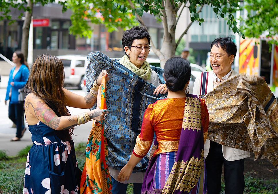 Performer with patrons at art on the plaza event at the Central Library