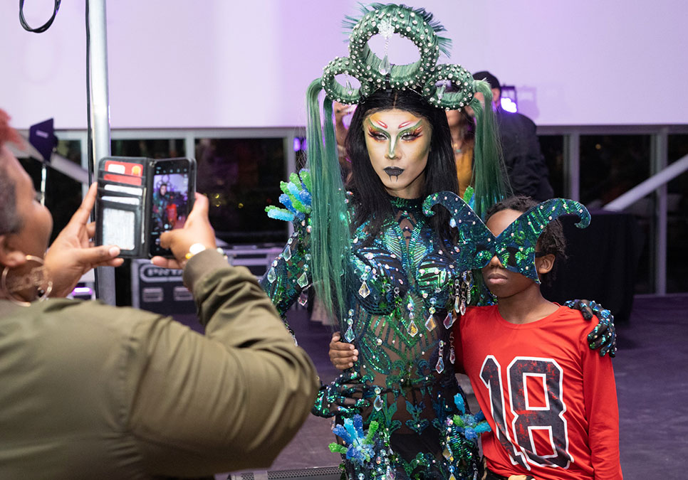A performer poses for a photo with a child at the at the Legendary Children event at the Olympic Sculpture Park in 2022