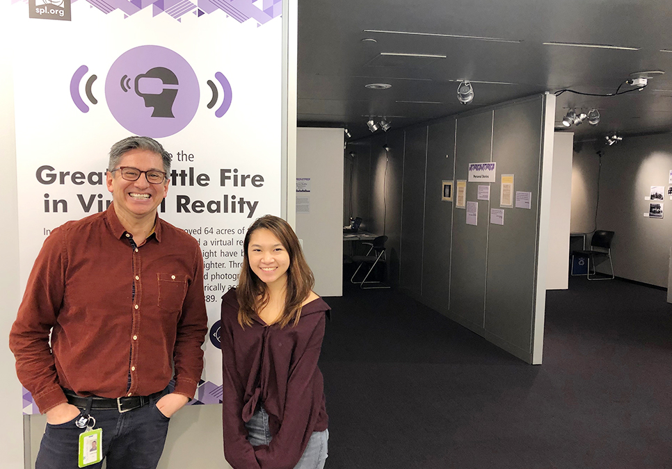 Library staff outside of Great Seattle Fire Virtual Reality exhibit at the Central Library