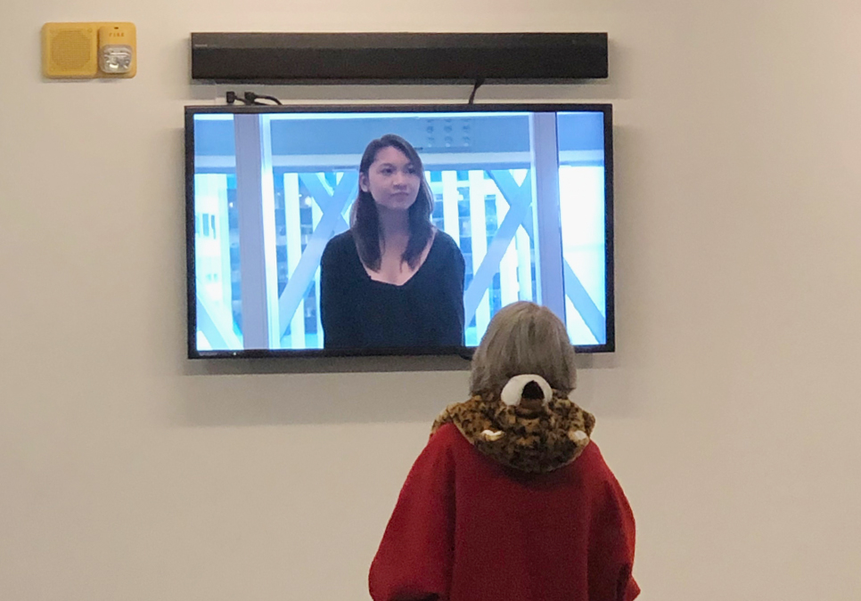 Patron watching Great Seattle Fire Virtual Reality exhibit video at the Central Library