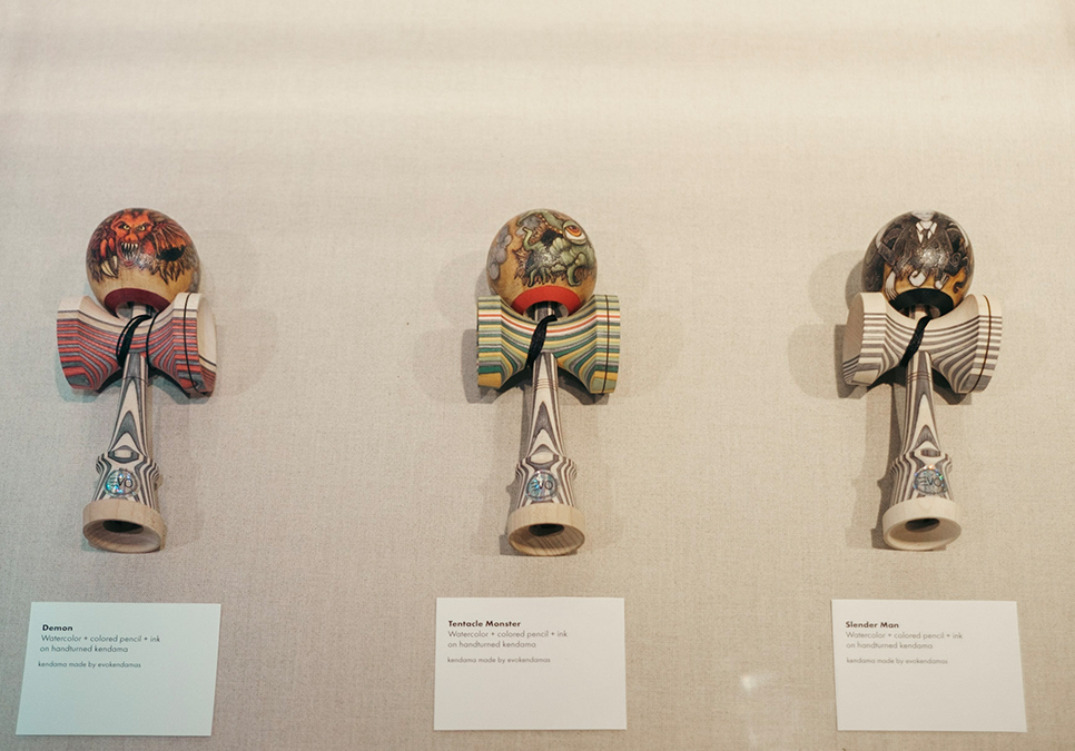 A close up of handmade kendamas on display at the Central Library Level 8 Gallery.