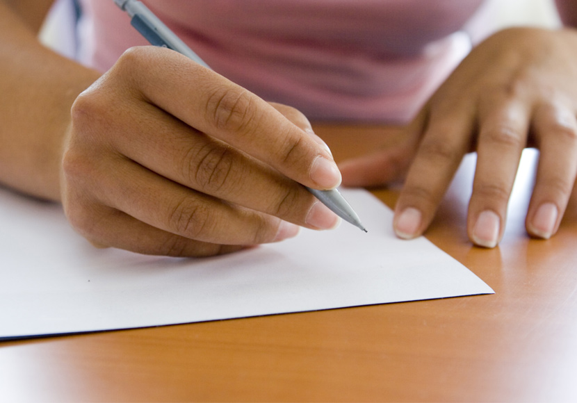 Person writing on paper