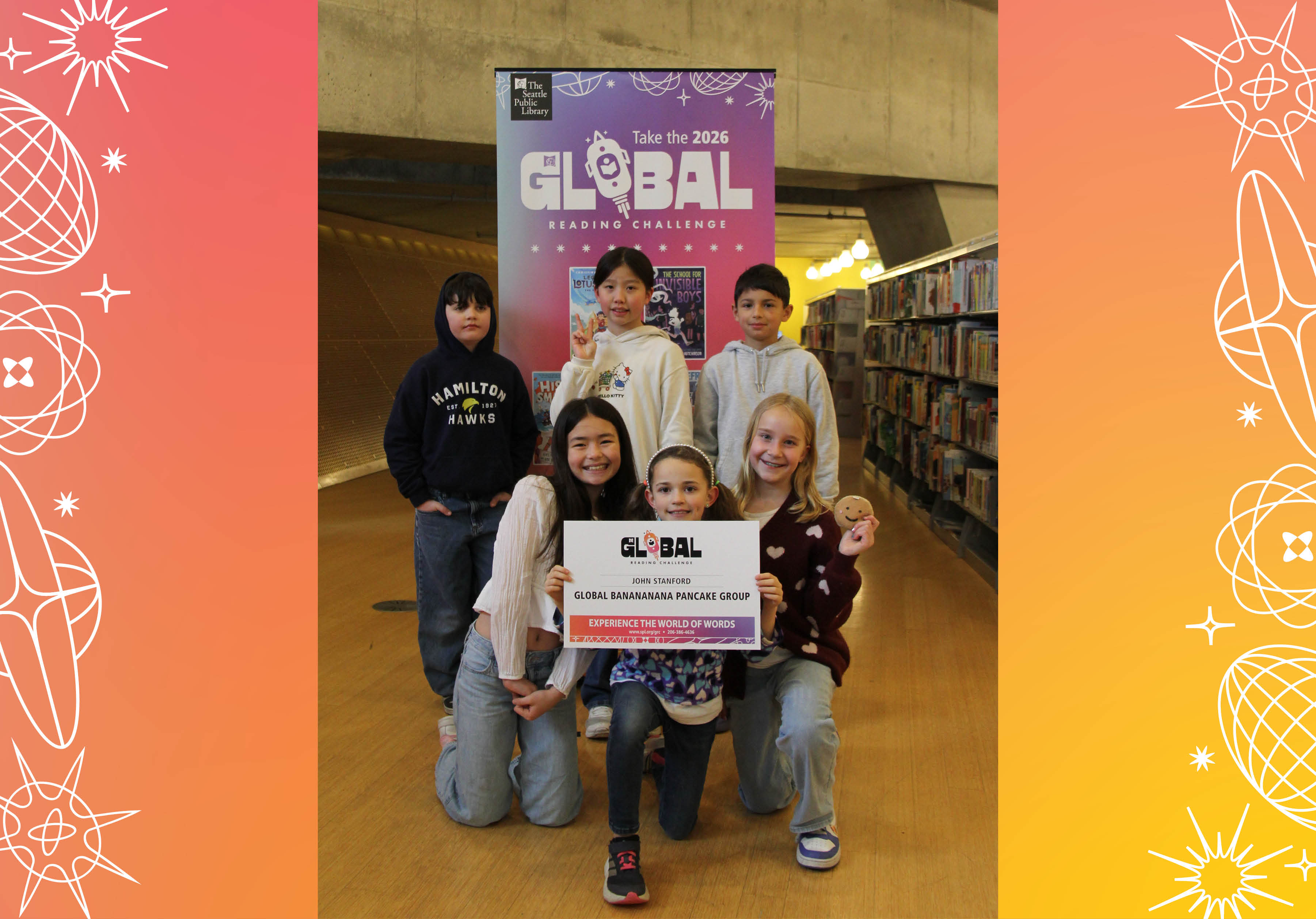 John Stanford’s Global Banananana Pancake Group posing with sign