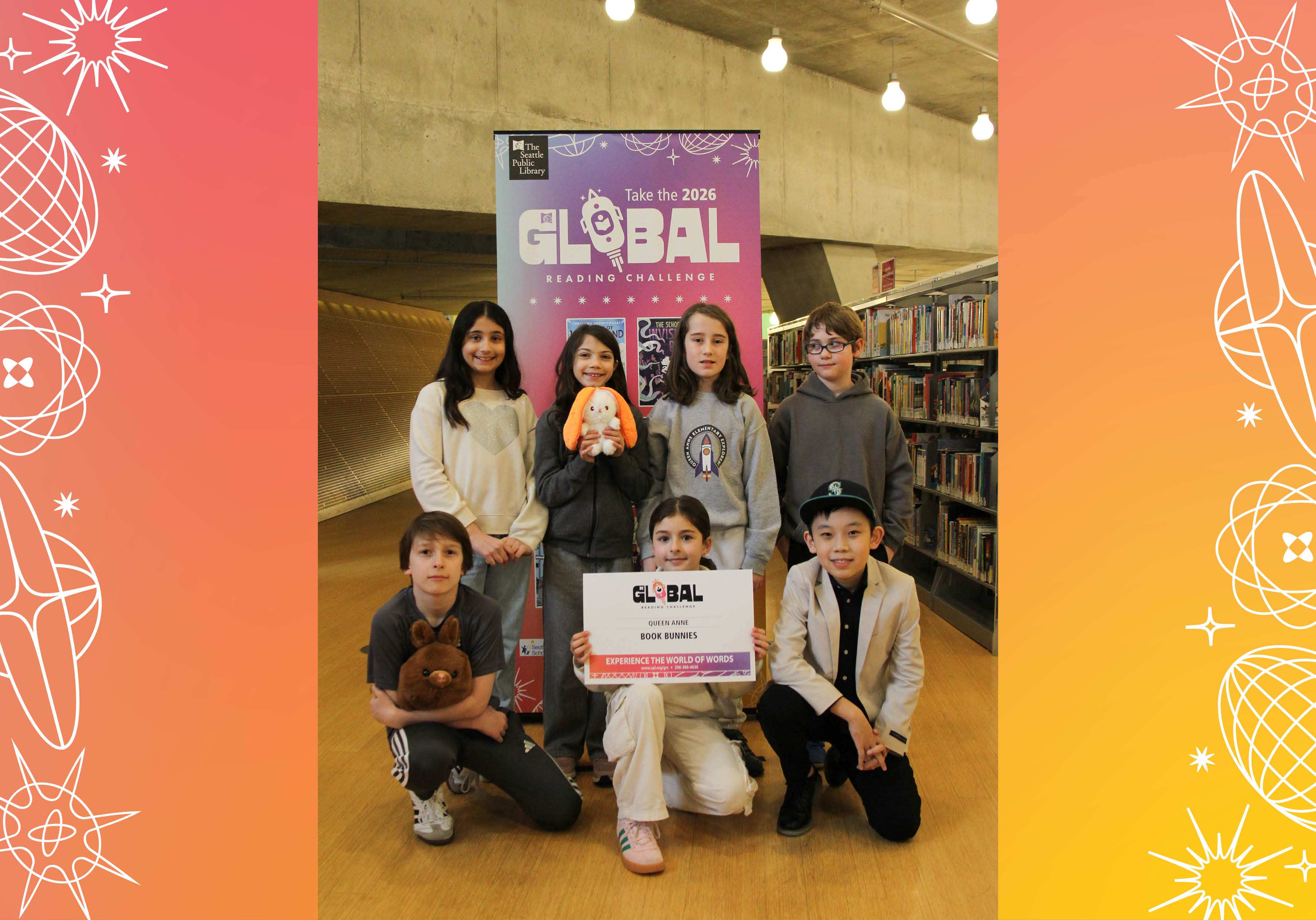 Seven members of Queen Anne's Book Bunnies posing with sign