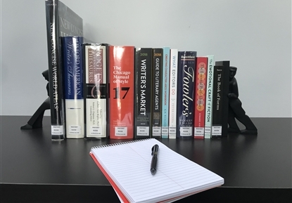 books with a notebook and pen