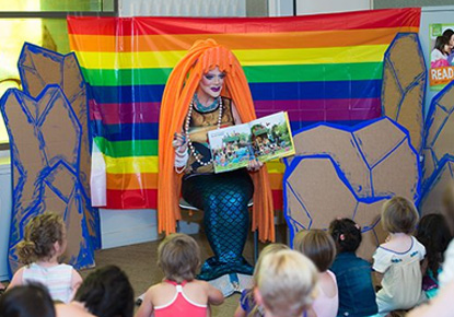 Drag queen reading to kids at Rainbow Story Time