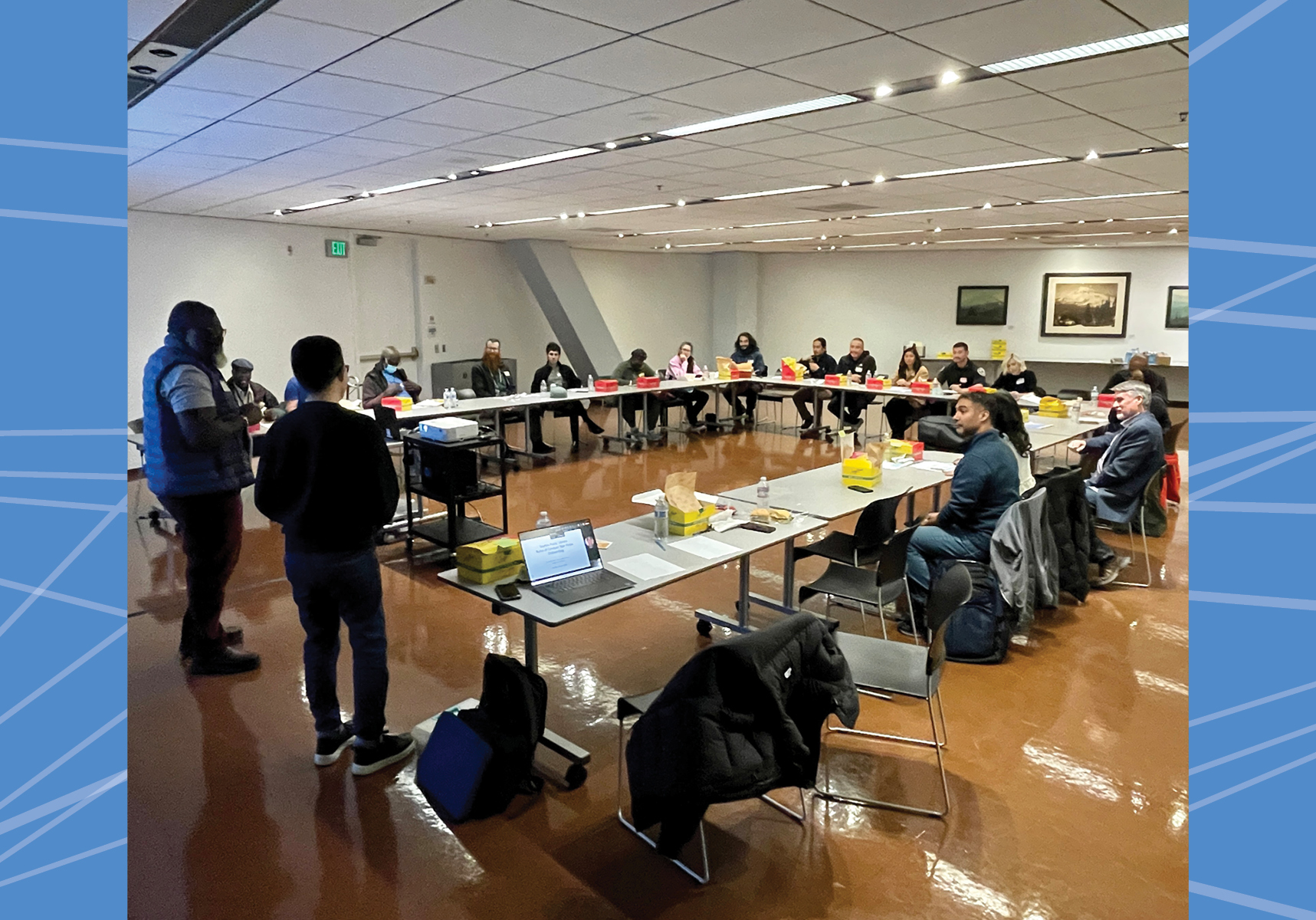 Task force participants sitting at and standing around a table.