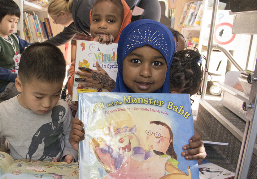 Children reading and showing books