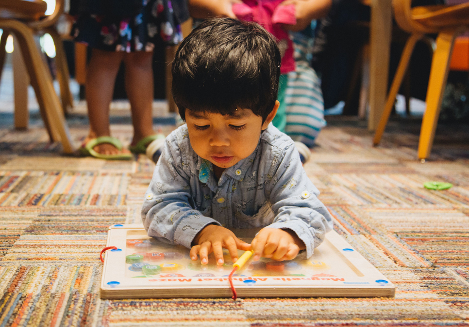 Young patron working a puzzle at the Fiestas program at South Park branch.