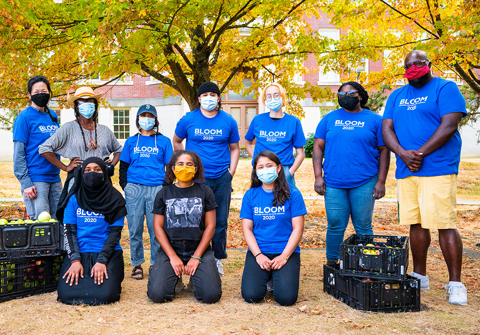 Masked participants posing for a group photo. BLOOM cider press in Jimi Hendrix Park, 2020. Photo courtesy of Dancing in the Rain. 