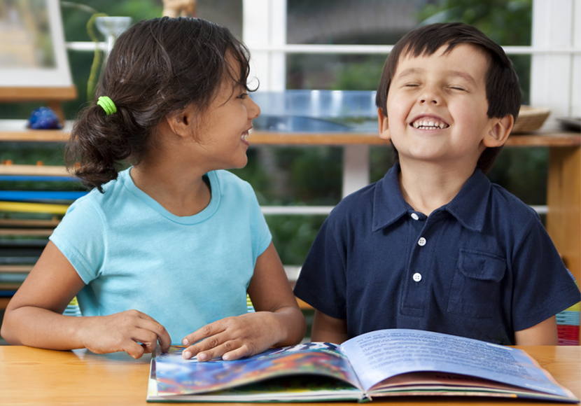 two children reading a book